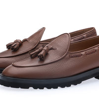 Superglamourous Tangerine 8T cognac deer leather loafers in three-quarter view, featuring leather tassels, braided side stitching and a chunky black lug sole. | Image 1