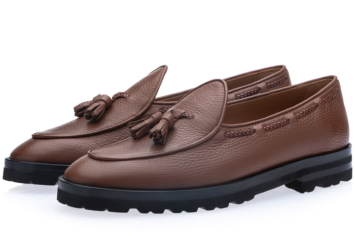 Superglamourous Tangerine 8T cognac deer leather loafers in three-quarter view, featuring leather tassels, braided side stitching and a chunky black lug sole.