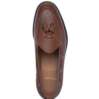 A single brown leather loafer shown from a top-down view on a plain white background. The shoe features a pebbled leather upper, a decorative tassel detail on the vamp, and a black outsole. | Image 4