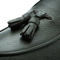 Close-up of Superglamourous Tangerine 8T musk green deer leather loafer, highlighting the textured leather, matching tassels, braided detail and tonal piping around the vamp. | Image 5
